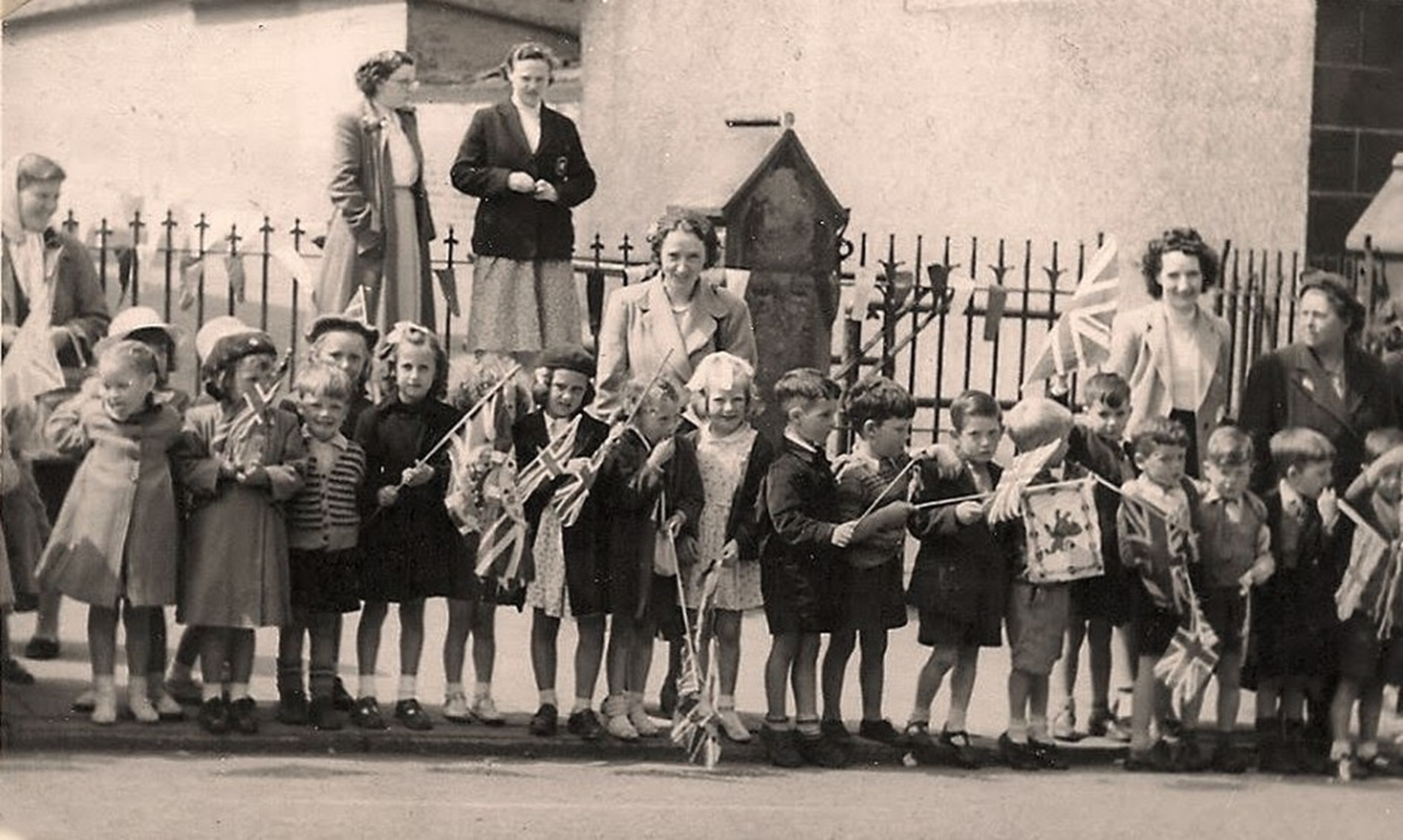 Pupils and Teacher's of St Patrick's School, Shieldmuir, Craigneuk, Wishaw, waiting for the Queen's Coronation Goodwill Tour, 1953. The teacher in the middle is Miss Winning, sister of Cardinal Winning, courtesy of Artúr Ceallaigh.