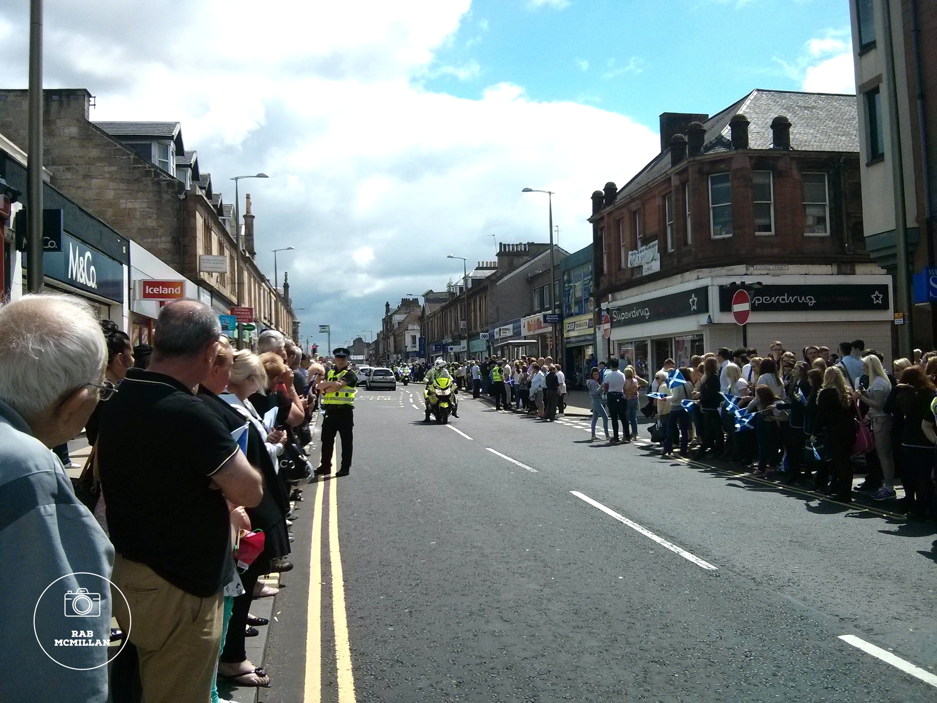 Waiting on the Queen's Baton Relay for the Commonwealth Games in Glasgow, Main Street, Wishaw, 2014.