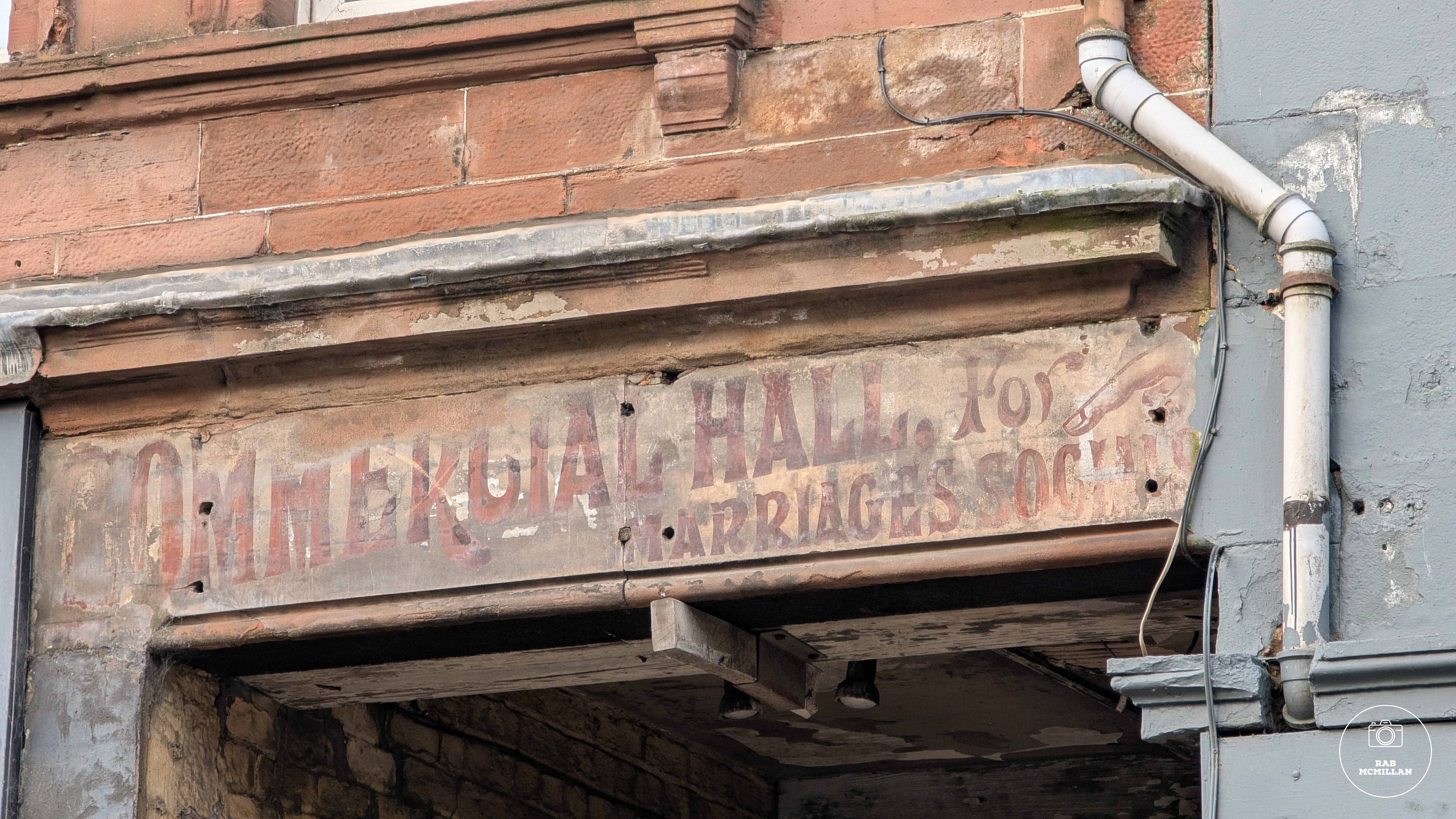 Early 1900's sign for Mrs Beattie's Commercial Hall, Main Street, Wishaw, 2025.