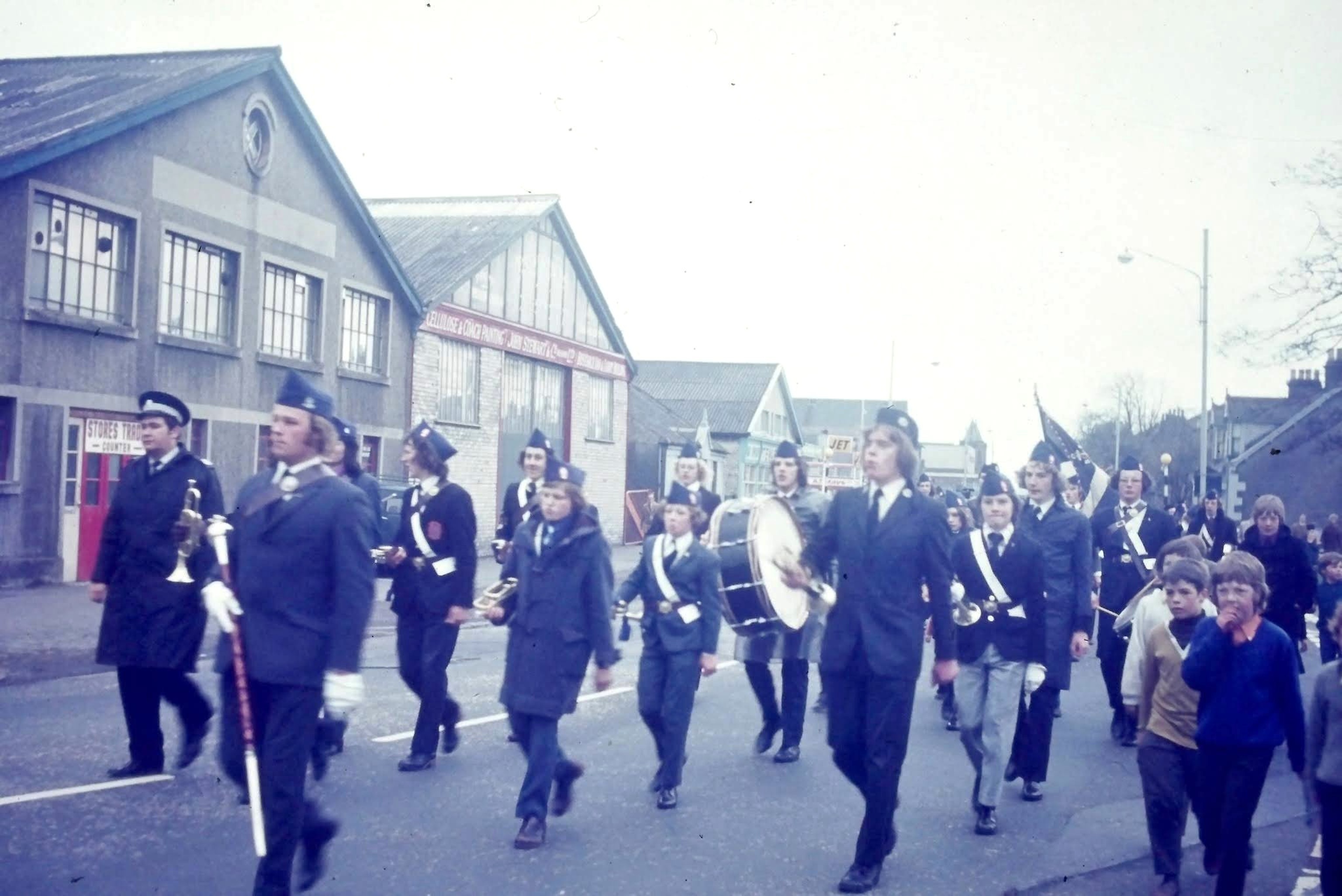 1st Cambusnethan Boys Brigade bringing home the Championship Trophy, 1973/74, passing Stewarts Coltness Coachworks, Kirk Road, Wishaw. Courtesy of Graeme Sutton.