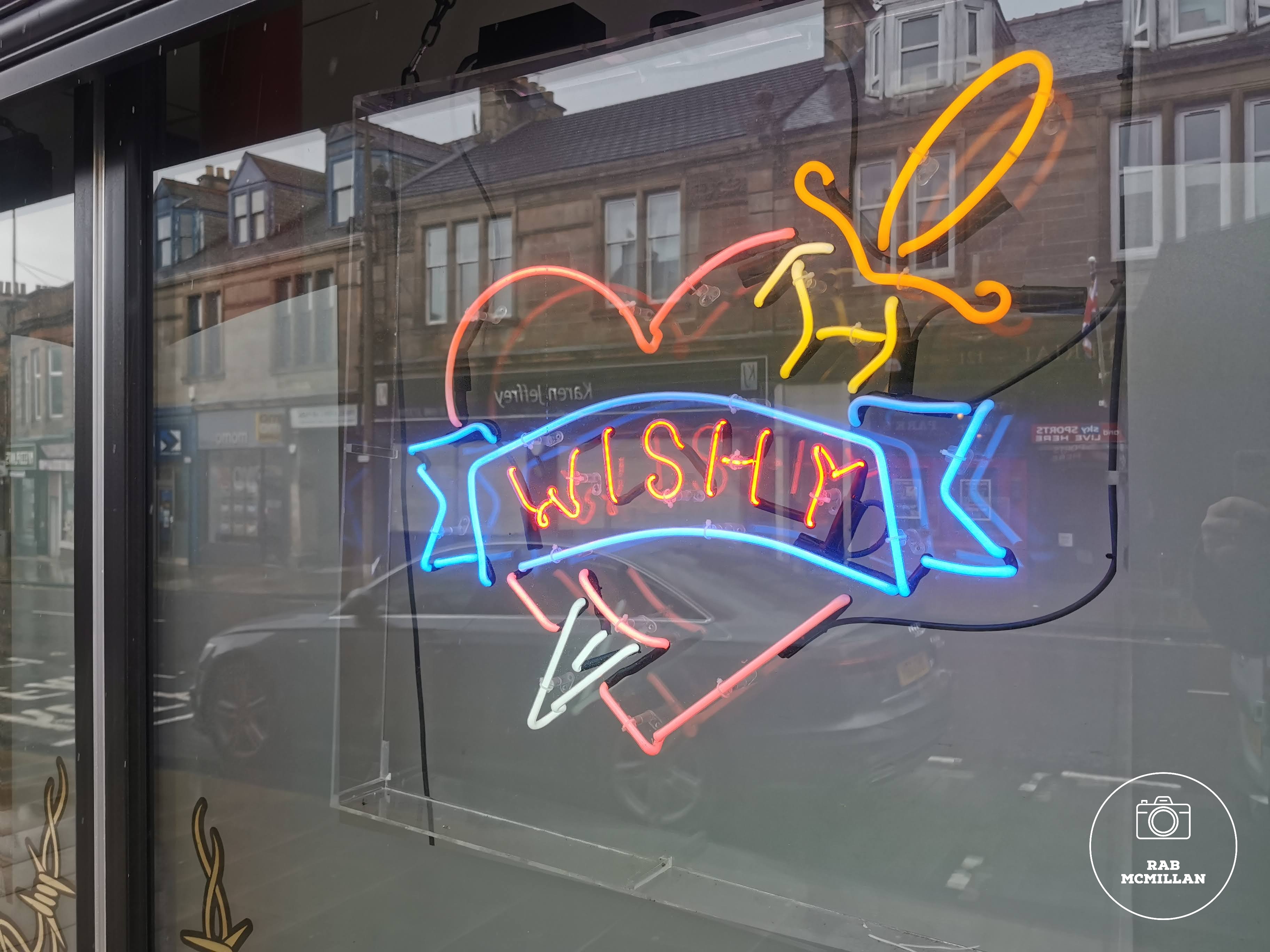 Window of Main Street Tattoo Parlour, Wishaw, 2023.