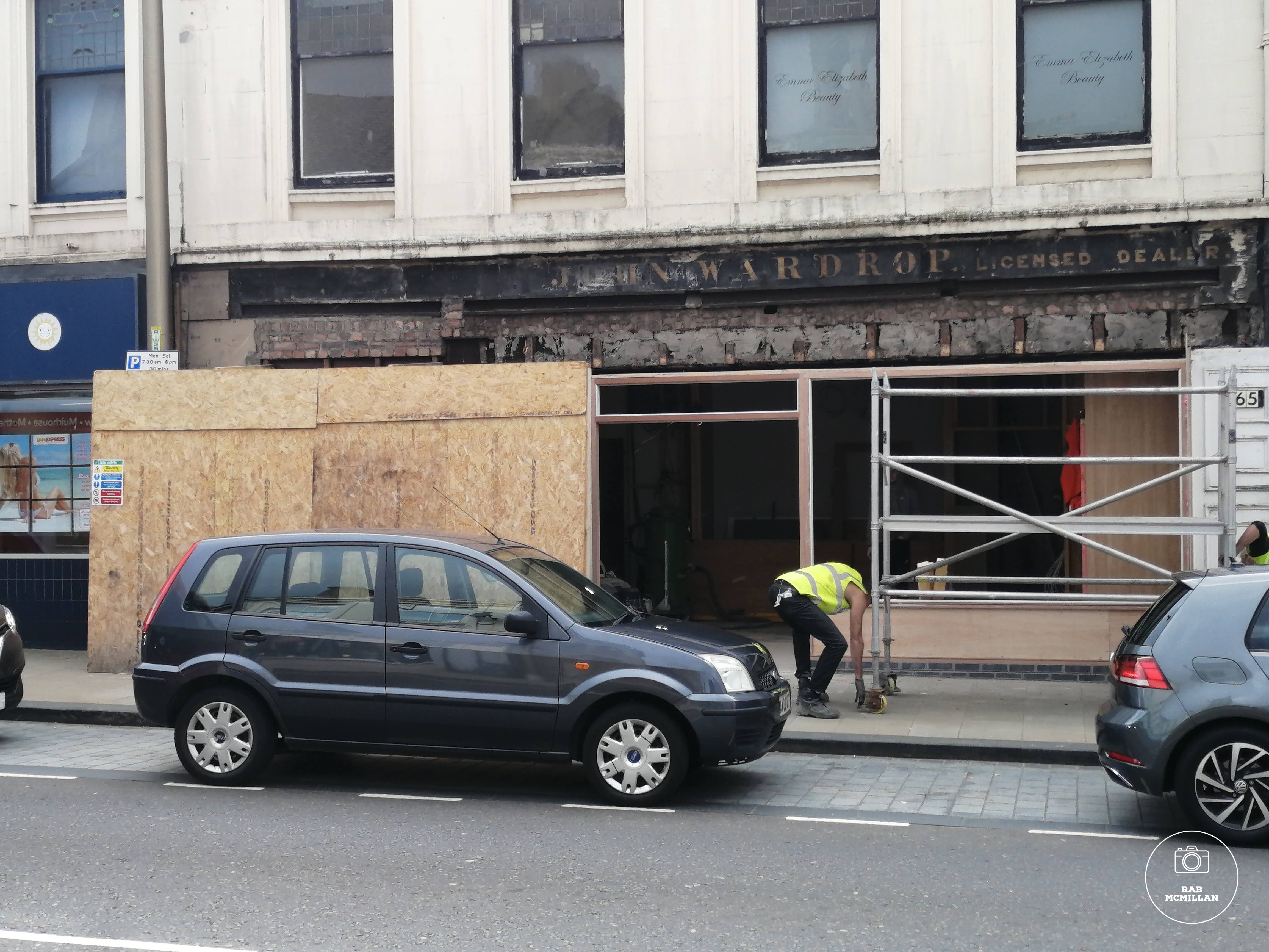 Hidden sign uncovered during renovations, Main Street, Wishaw, 2020.