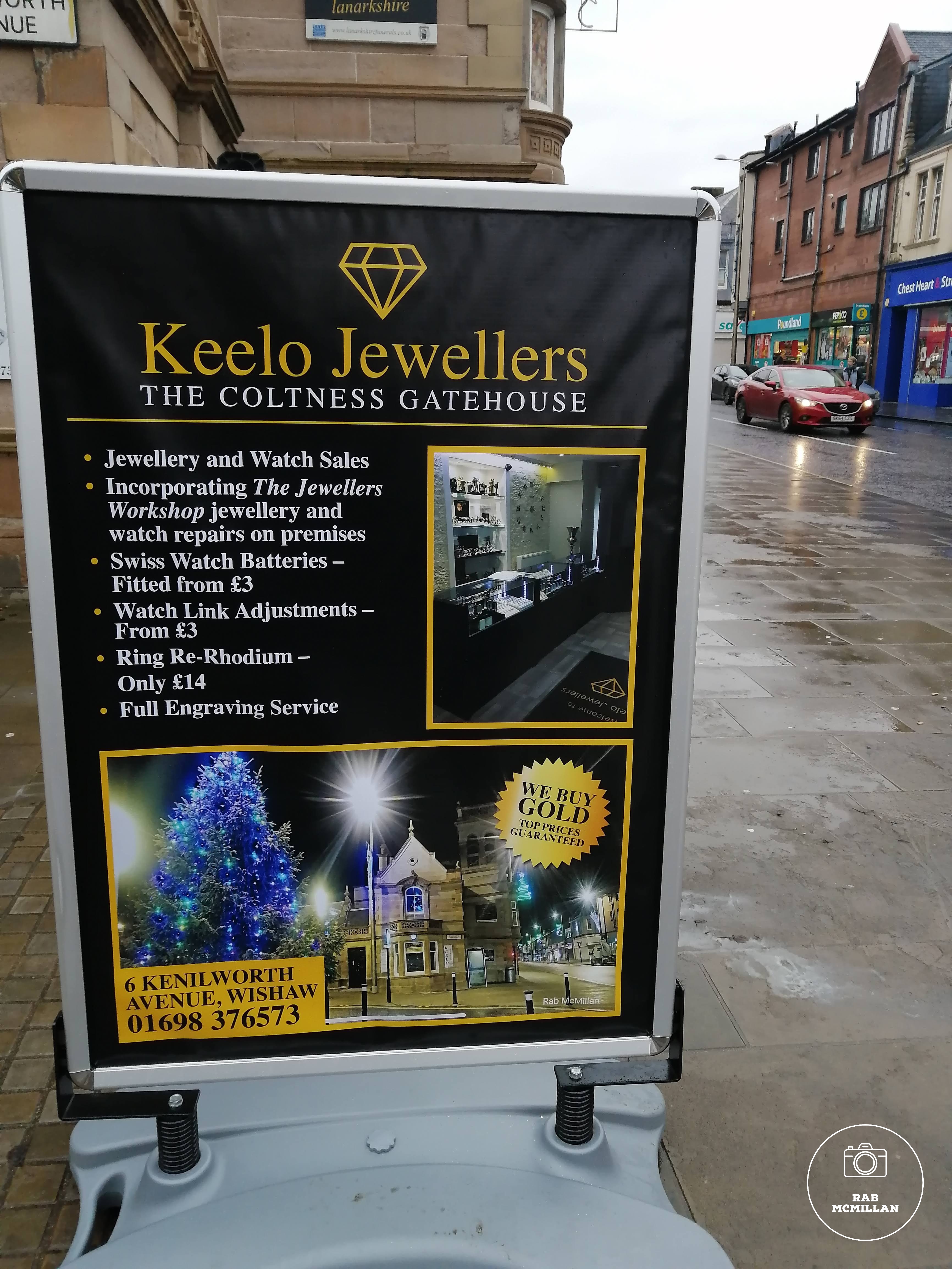 One of my photos "bottom pic" used by Keelo Jewellers on their advertising board, Main Street, Wishaw, 2019.